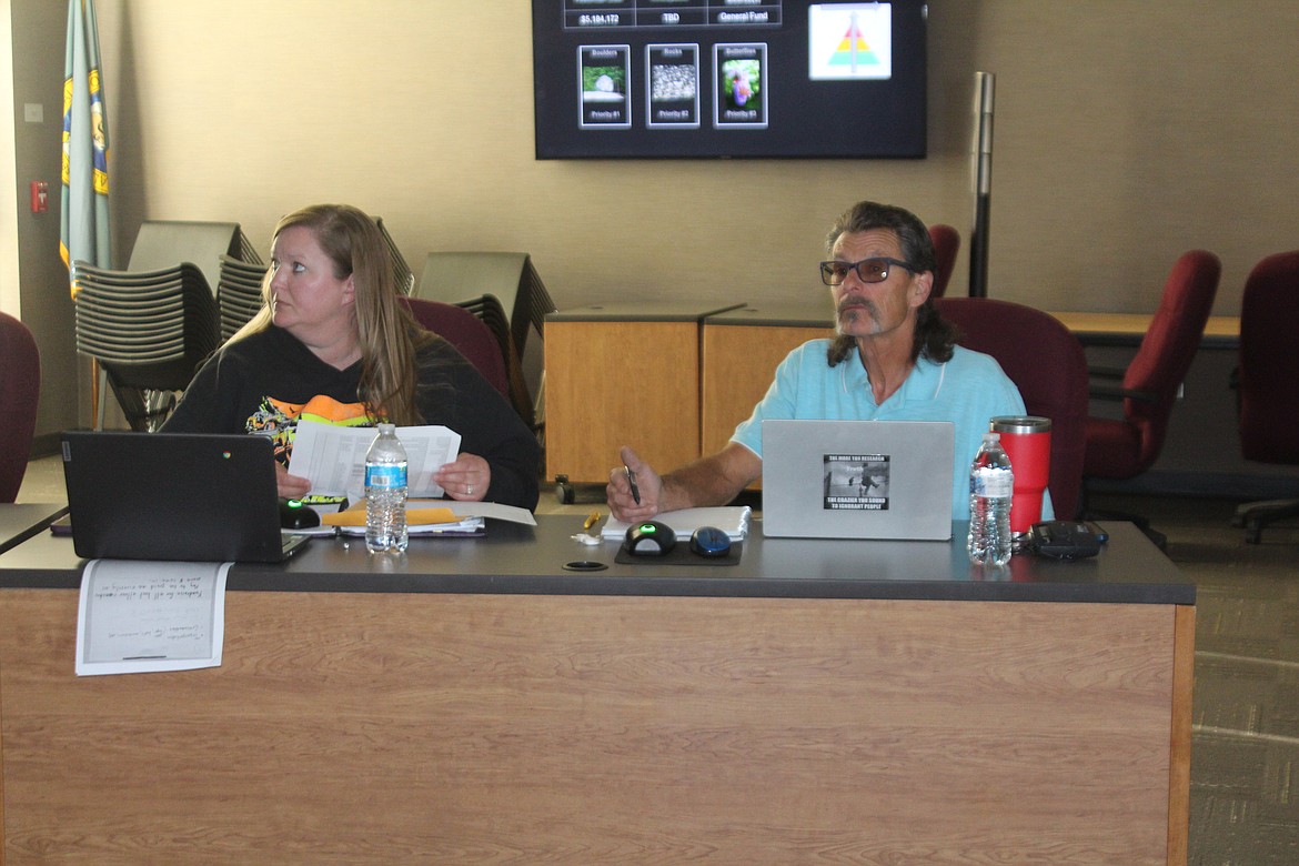 Moses Lake School Board members Kirryn Jensen, left, and Paul Hill, right, consider funding priorities during a special meeting Tuesday.