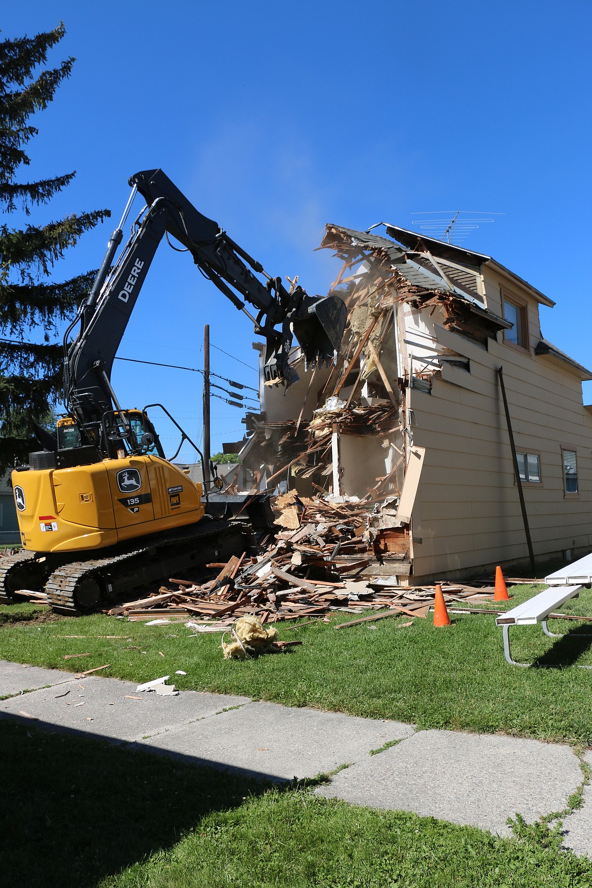 Jim Woodward of Apex Construction Services maneuvers into position to take a works to tear down an aging duplex owned by Bonner Homeless Transitions. The site will eventually be home to multiple one-bedroom apartments, allowed the transitional housing program to help even more in the community.