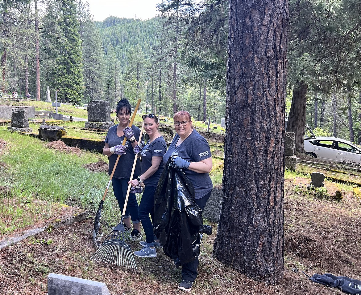 Mountain West Bank employees Janis Barker, Amber Ruppert, and Tanya Picker were among the people helping clean up Nine Mile Cemetery on Wednesday. Much of the work involved raking up woody debris and pine needles and getting it bagged.