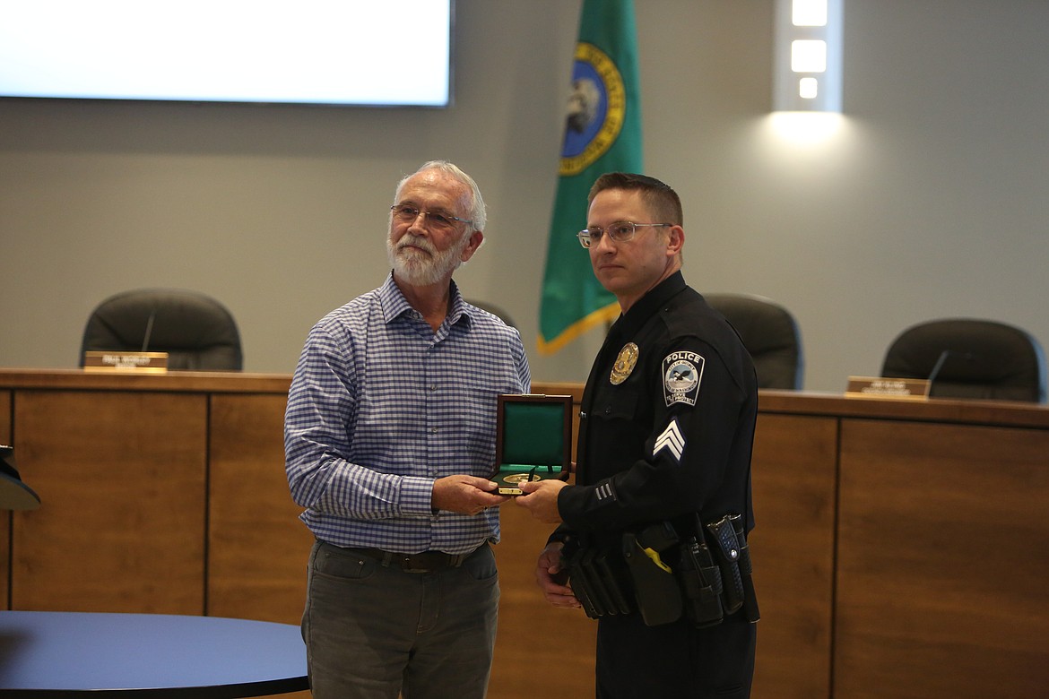 Quincy Police Department Sgt. Stephen Harder, right, and U.S. Congressman Dan Newhouse, left, smile for a photo after Newhouse presented Harder with the Carnegie Hero Fund Medal on Thursday in Quincy.