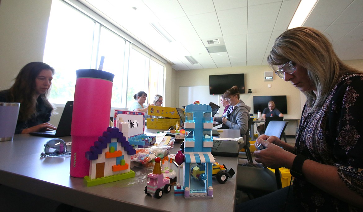 Northside Elementary School teacher Johanna Soderberg, left, and Valley View Elementary teacher Shelly Hoisington participate Thursday morning in the "Explore the World through Lego" strand during the i-STEM Institutes at North Idaho College.