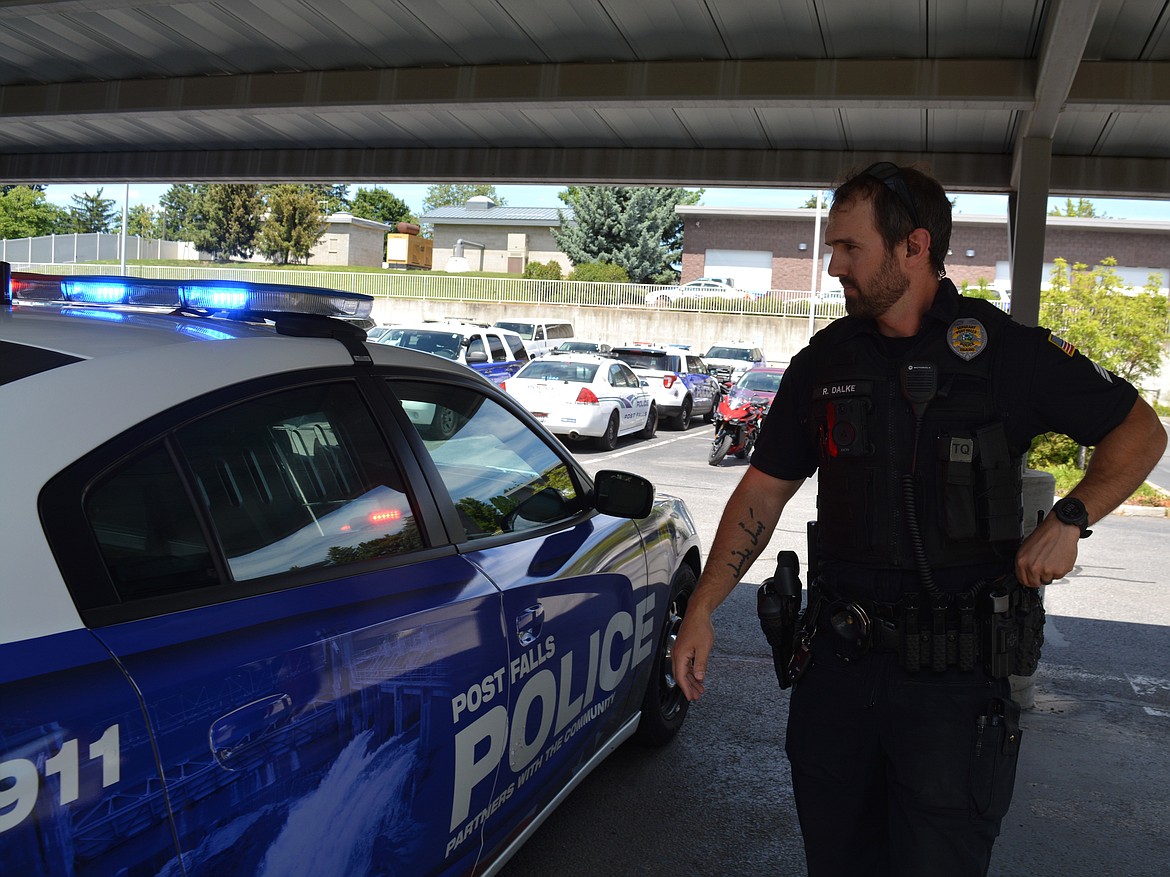 Post Falls Police Sgt. Ryan Dalke tests the lights on his police vehicle. Staffing the department proportionate to the growing population of Post Falls has been an issue over the last few years, with the lowest staffing count occurring six months ago.