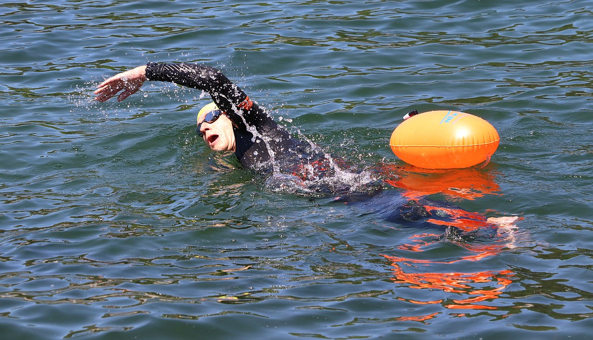 Alex Smith heads out for a swim in Lake Coeur d'Alene on Friday.