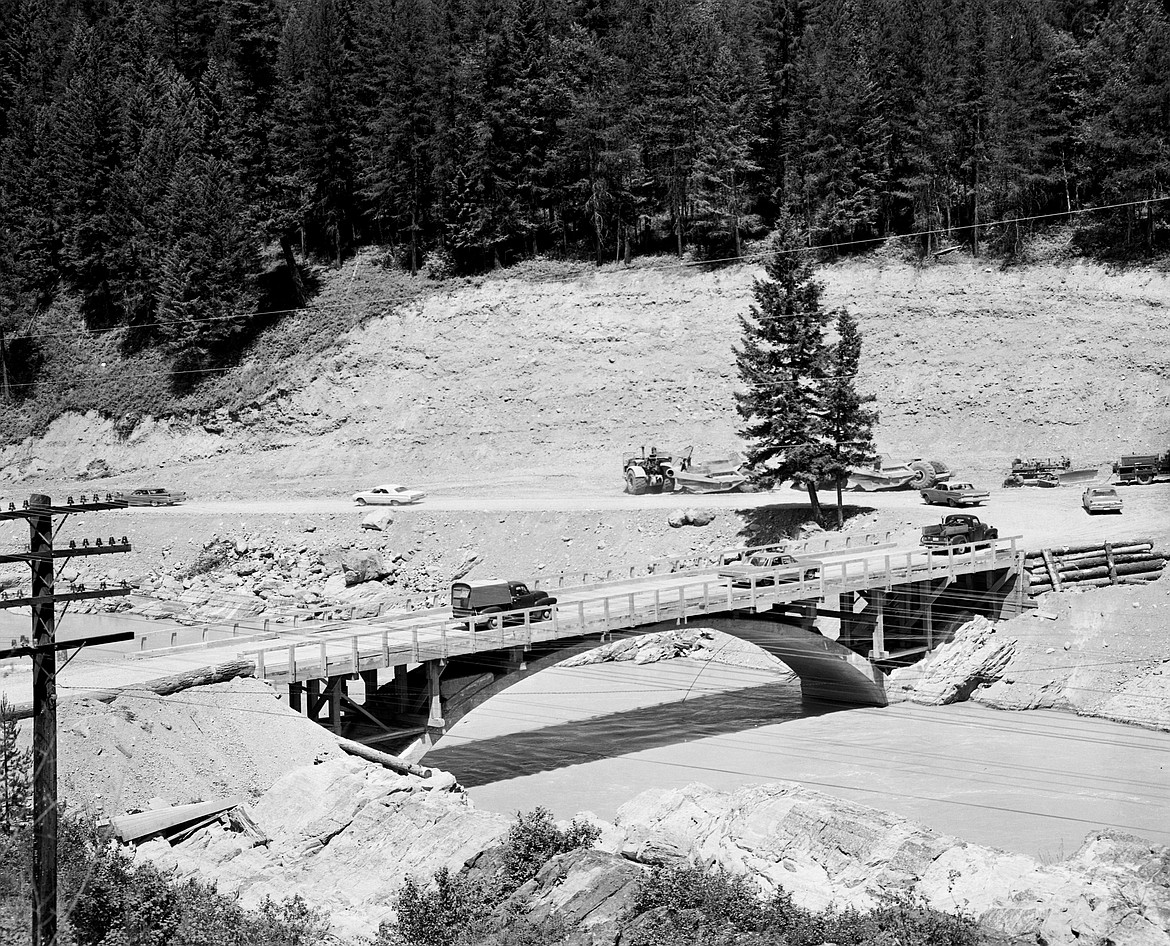 Traffic goes over the rebuilt Belton Bridge in West Glacier after the Flood of '64. This photo was taken June 28, 1964. The flood destroyed the deck of the bridge but left the arch. It became the new entrance to Glacier National Park until the destroyed bridge in West Glacier townsite could be rebuilt. (Mel Ruder/Hungry Horse News)