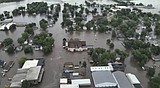 Helicopters scramble to rescue people in flooded Iowa town while much of US toils again in heat