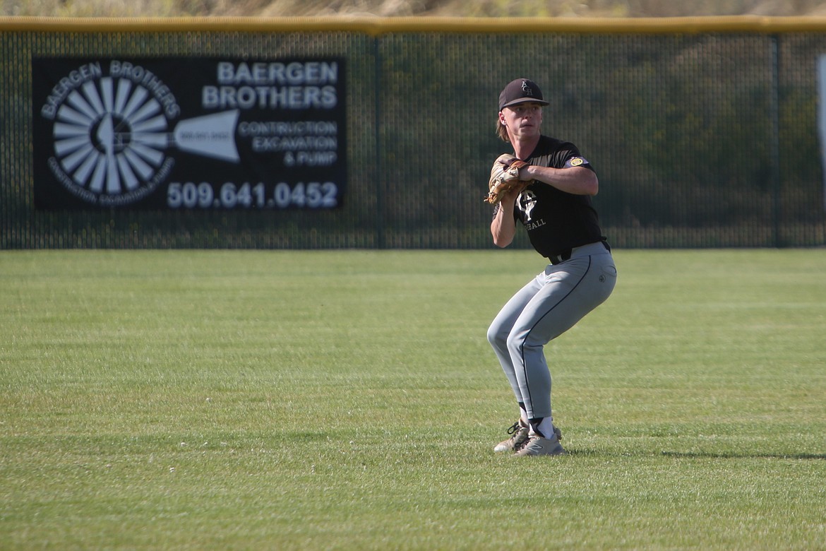 Almira/Coulee-Hartline Legion center fielder Harvest Parrish looks to throw the ball bask toward the infield during the bottom of the first inning against East Valley.
