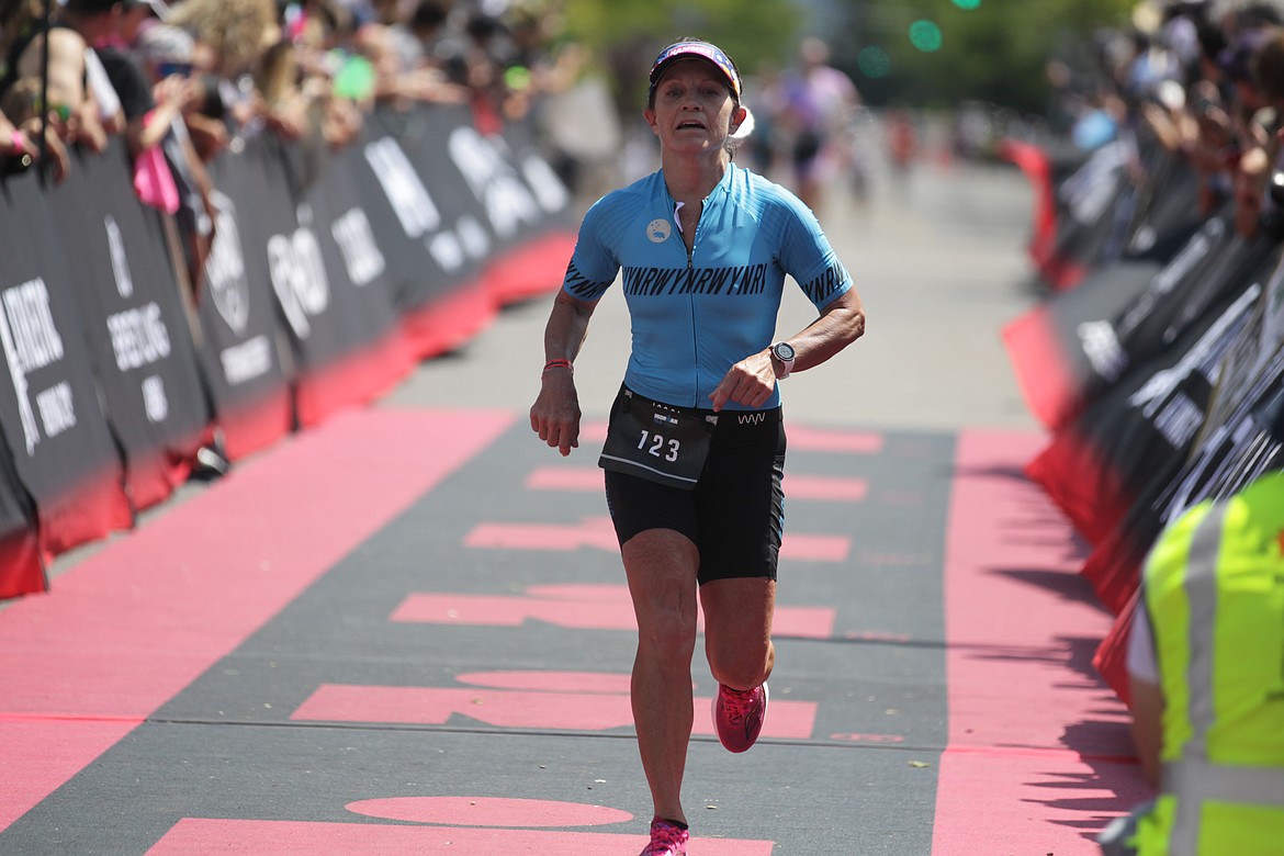 JASON ELLIOTT/Press
Hayden's Suzanne Endsley comes across the finish line in Sunday's Ironman 70.3 Coeur d'Alene.