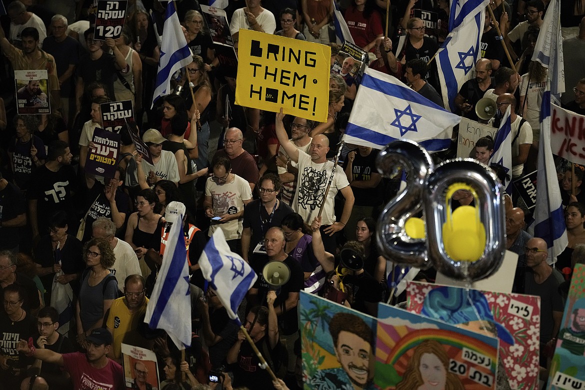 People protest against Israeli Prime Minister Benjamin Netanyahu's government and call for the release of hostages held in the Gaza Strip by the Hamas militant group, in Tel Aviv, Israel, Saturday, June 22, 2024. (AP Photo/Leo Correa)