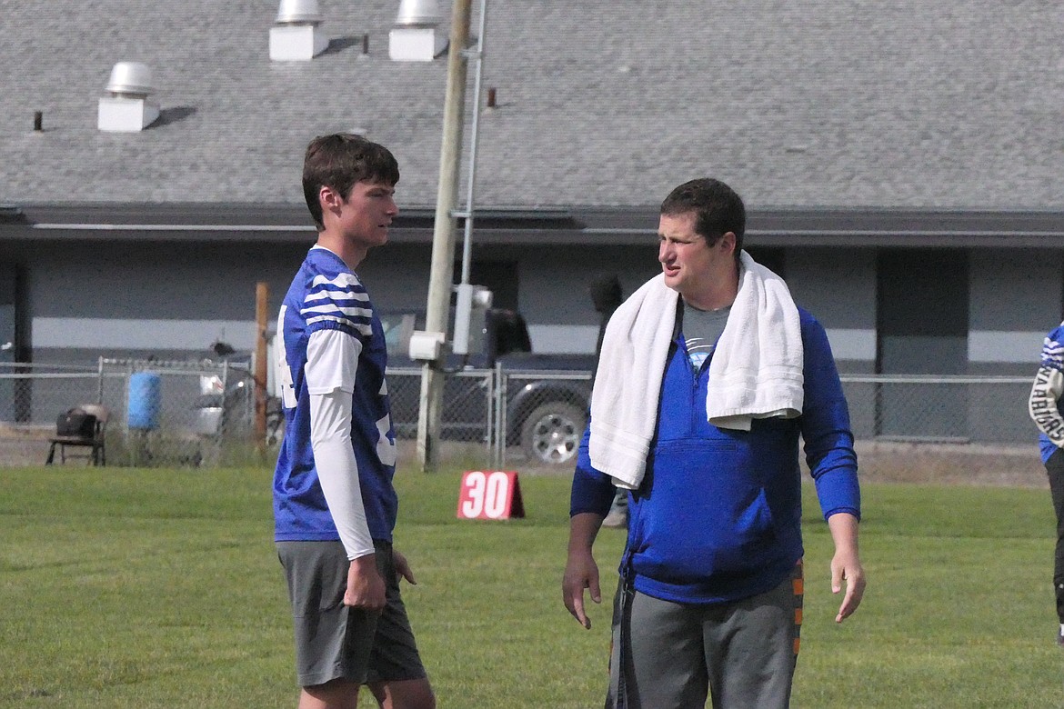 Superior coach Jeff Schultz works with sophomore Landon Richards during a 5-on-5 Passing League game last week in Superior.