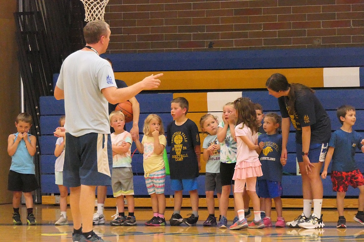 Coach Jake Mickelson talks with the kindergarten to second grade group at last week's  T Falls Basketball Camp.  (Chuck Bandel/VP-MI)
