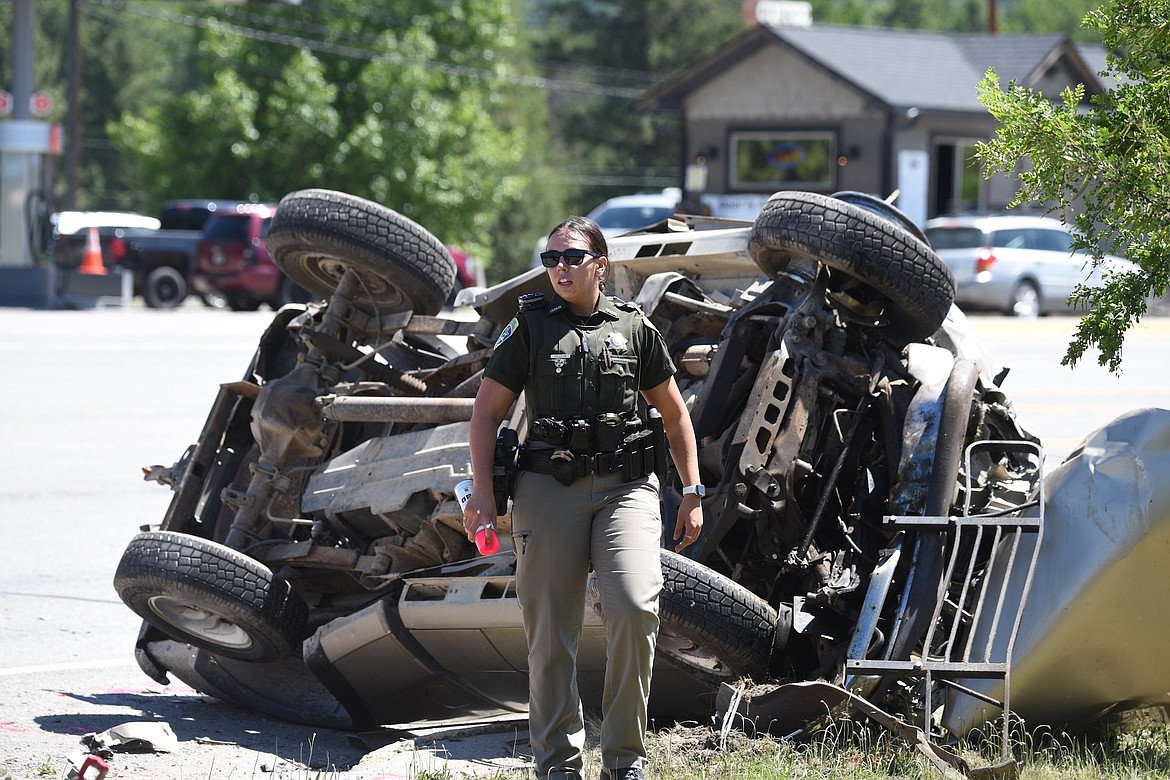 Montana Highway Patrol Trooper Jessica Lyles works the scene of a two-vehicle accident Saturday, June 8, 2024, on U.S. 2 near Bear's Country Store. (Scott Shindledecker/The Western News)