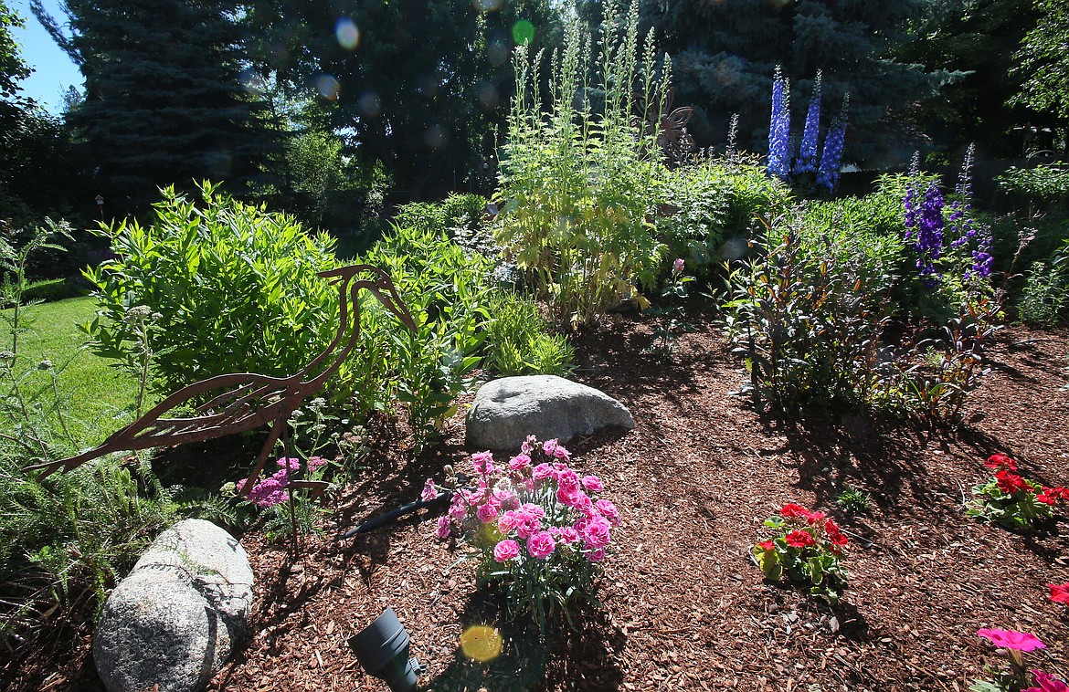 A wading bird sculpture and an array of colorful flowers and plants are sights to see in Marilyn Nenzel's Hayden garden.