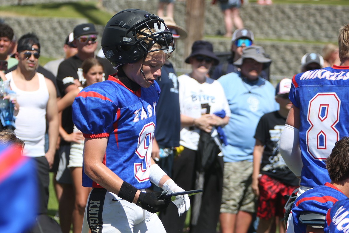 Royal wide receiver/defensive back Case Christensen looks at the East Offensive Most Valuable Player plaque at Saturday’s Earl Barden Classic in Yakima.