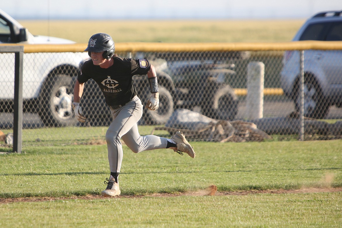 Almira/Coulee-Hartline Legion center fielder Harvest Parrish rushes toward home plate during the nightcap of Friday’s doubleheader against East Valley.