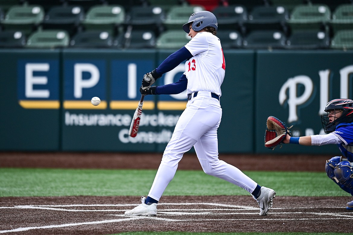 Badrock's Logan Stewart (13) connects on a two-run inside-the-park home run against Libby during the Badrock Invitational at Glacier Bank Park on Thursday, June 27. (Casey Kreider/Daily Inter Lake)