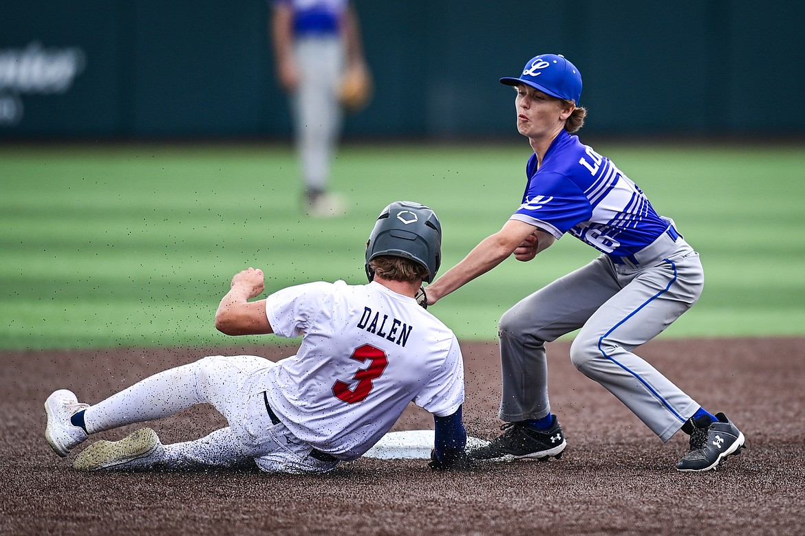 Libby second baseman Carson Wolgamott (6) puts the tag on Badrock's Luke Dalen (3) after Dalen got caught in a rundown between second and third during the Badrock Invitational at Glacier Bank Park on Thursday, June 27. (Casey Kreider/Daily Inter Lake)