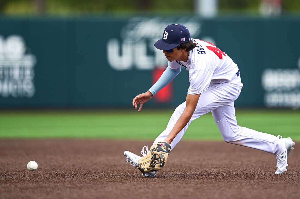 Badrock second baseman Carson Bramme (44) charges a ground ball against Libby during the Badrock Invitational at Glacier Bank Park on Thursday, June 27. (Casey Kreider/Daily Inter Lake)