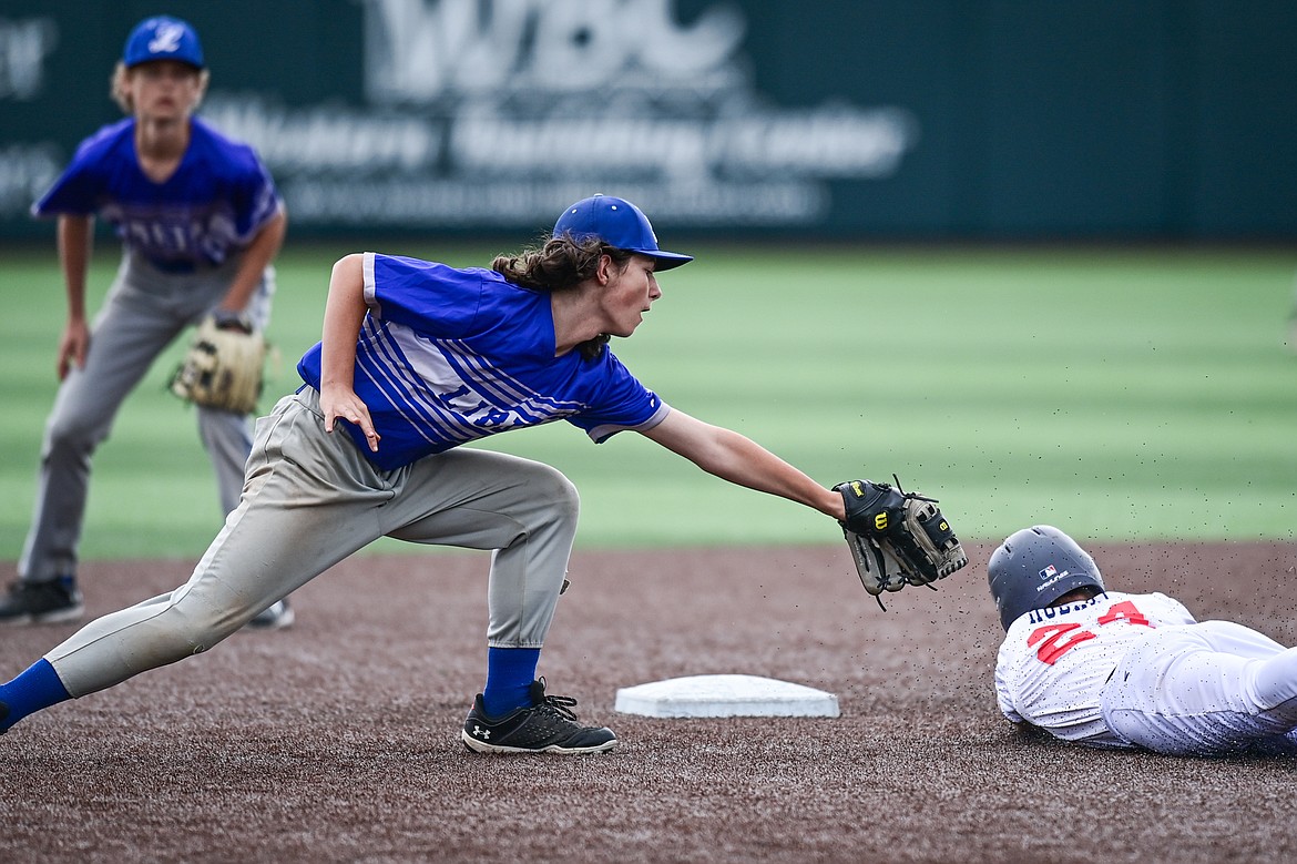 Libby shortstop Riley Stoltz (19) puts the tag on Badrock's Reyd Hobart (24) after Hobart got caught in a rundown between second and third during the Badrock Invitational at Glacier Bank Park on Thursday, June 27. (Casey Kreider/Daily Inter Lake)