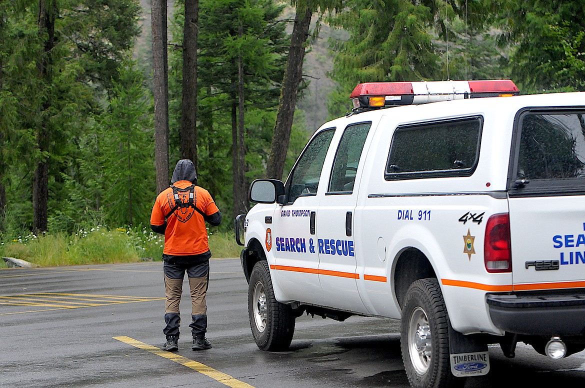 A member of David Thompson Search and Rescue begins a search Thursday from the overflow parking lot at Kootenai Falls for a woman missing in the Kootenai River. (Taylor Resch/The Western News)