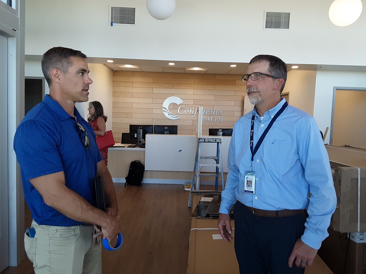 Gregg Fletcher, right, and Aaron Binger of Confluence Health discuss the finishing touches during construction of the organization’s specialty care clinic in Moses Lake in 2021.