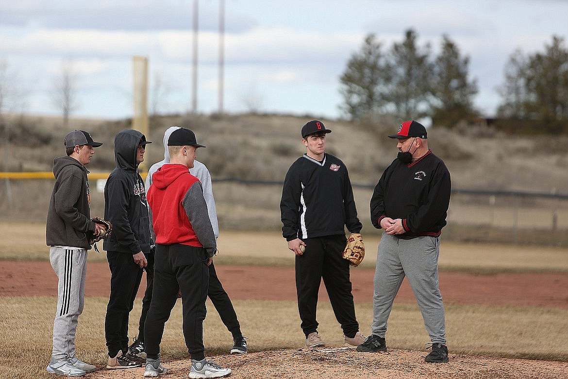 Lind-Ritzville Sprague baseball Head Coach Jason Hilzer, right, works with players during a practice in the 2023 season. Hilzer, who also coaches football and wrestling, battled against leukemia during the 2021-22 school year before returning to coach in 2022.