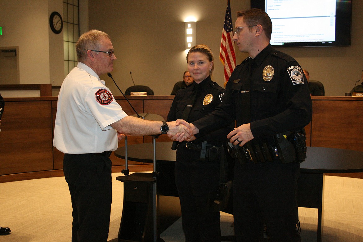 Grant County Fire District 3 Chief Tony Leibelt, left, presents lifesaving awards to Quincy Police Department Officer Stephen Harder, left, and QPD Sergeant Jazzlyn Silva, center in February 2023. The two officers entered a burning house and saved a woman inside.