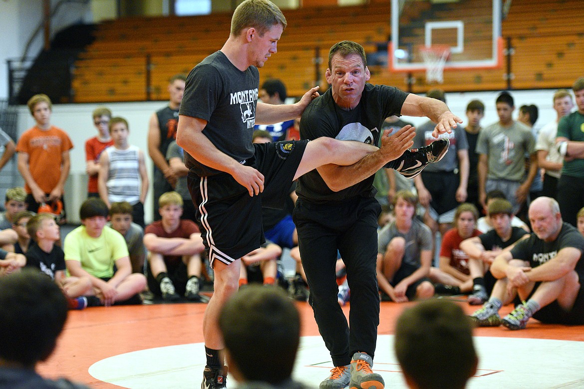 Flathead High School wrestling head coach Jeff Thompson, right, works with Justin Whitman, an assistant coach with Flathead, during the Montana Intensive Wrestling Camp at Flathead High School on Thursday. (Casey Kreider/Daily Inter Lake)