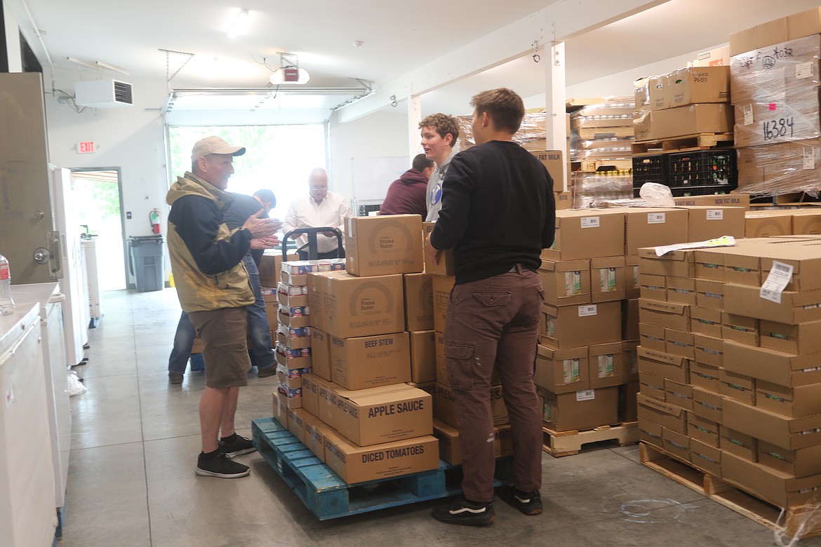 Volunteers organized a Thursday donation from the Church of Jesus Christ of Latter-day Saints into bundles being distributed to food banks in the region.