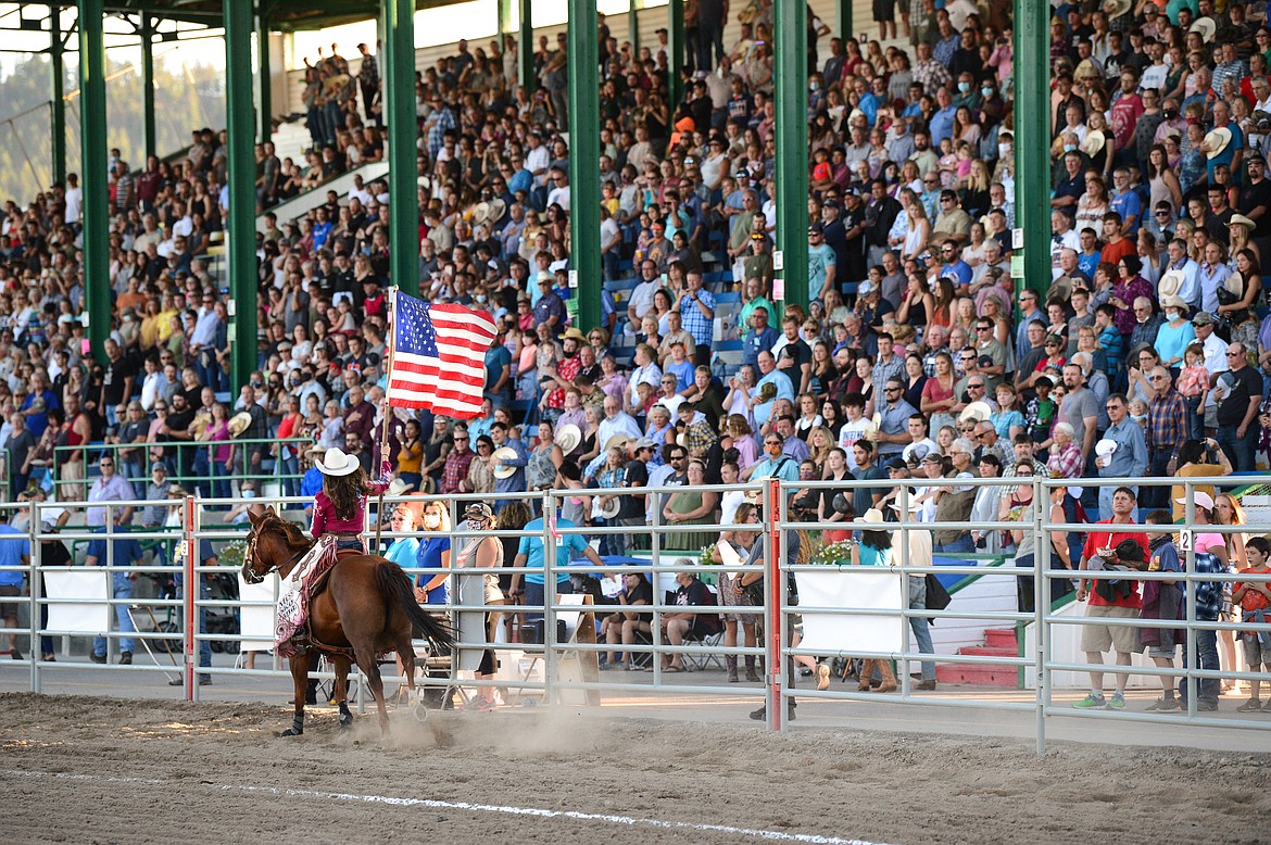 Fans stand for the singing of the national anthem at the Northwest Montana Fair & Rodeo at the Flathead County Fairgrounds in Kalispell on Saturday, Aug. 22. (Casey Kreider/Daily Inter Lake)