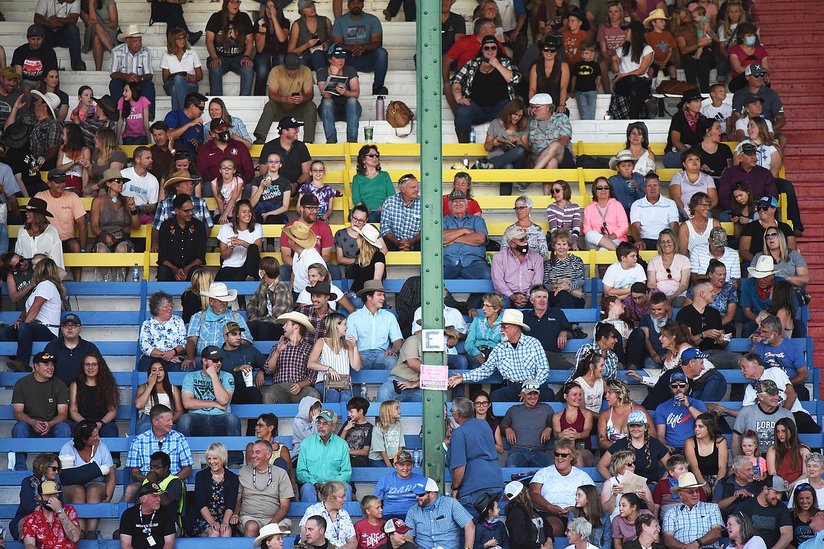 Fans in the grandstand converse during a break in the action at the Northwest Montana Fair & Rodeo at the Flathead County Fairgrounds in Kalispell on Saturday, Aug. 22. (Casey Kreider/Daily Inter Lake)