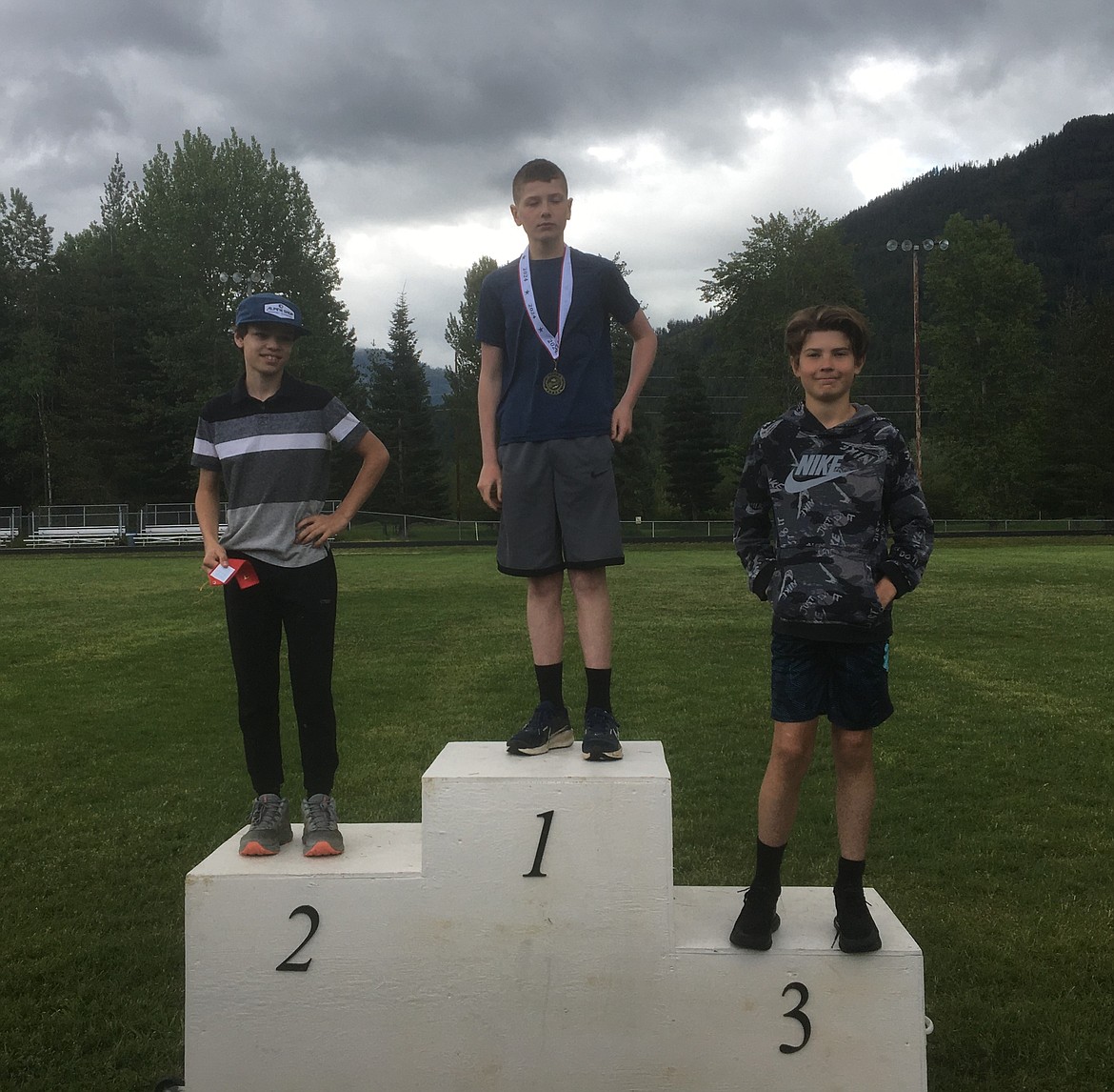 A trio of boys stand on the podium after finishing amongst the top three in an event at one of the Sandpoint Parks and Recreation's youth track and field meets held at Sandpoint High this past spring.