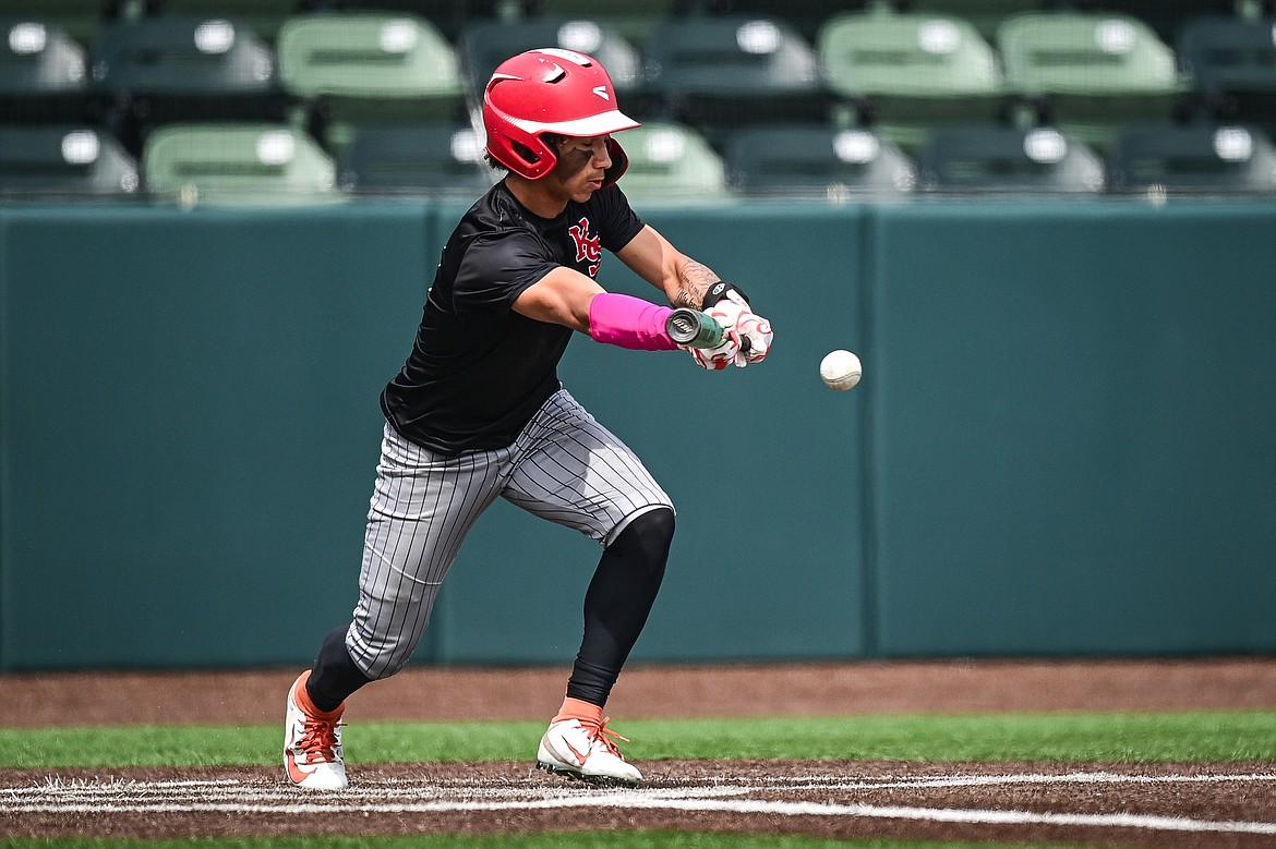 Kalispell Sluggers' Jordan Griffin (0) drives in a run with a bunt single against Badrock during the Badrock Invitational at Glacier Bank Park on Saturday, June 29. (Casey Kreider/Daily Inter Lake)