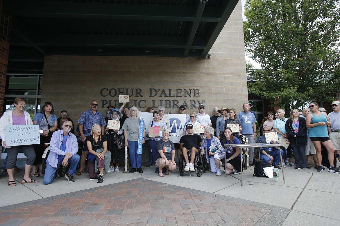 Nearly 40 people gather outside of the Coeur d'Alene Public Library during a demonstration Monday in support of local libraries. Rallies were held across the state as House Bill 710 went into effect.