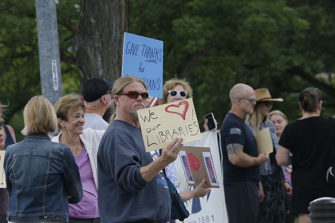 Mike Cooper of Post Falls and other supporters rally for libraries Monday during a demonstration outside of the Coeur d'Alene Public Library.