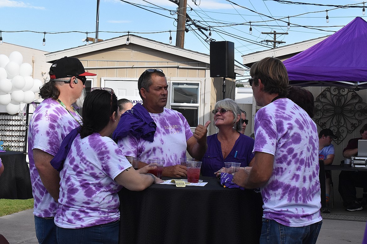 Purple Party attendees visit during a prior year’s event. This year is the tenth Purple Party which gives people an opportunity to plan a team to participate in the Walk to End Alzheimer’s and to raise funds to support research to end the disease.