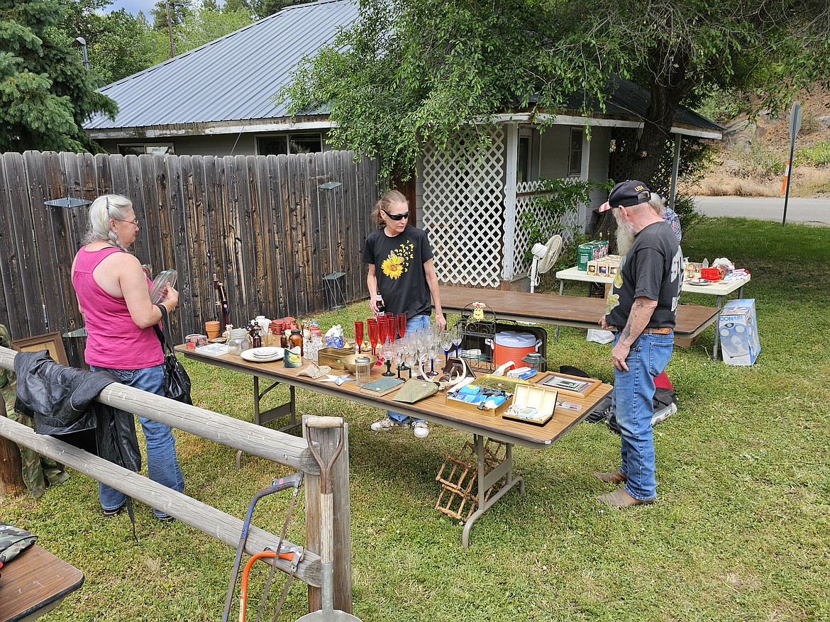 Shoppers in Plains check out items for sale at a yard sale in Paradise during the annual Sanders County Yard Sale event this past weekend. (Chuck Bandel/VP-MI)