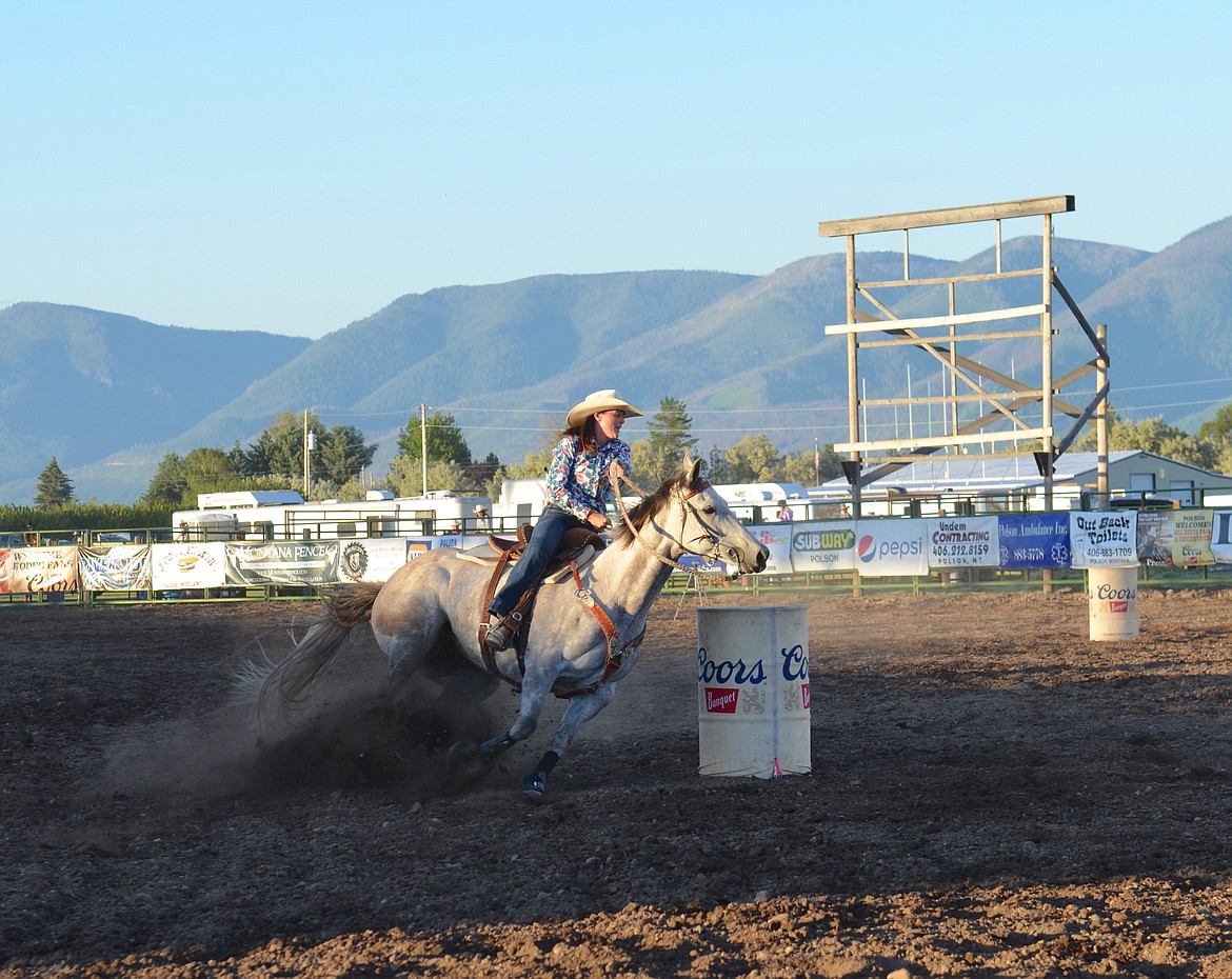 Rider cuts around the final barrel before heading to the finish line at the Mission Mountain Rodeo, held last weekend at the Polson Fairgrounds. (Kristi Niemeyer/Leader)