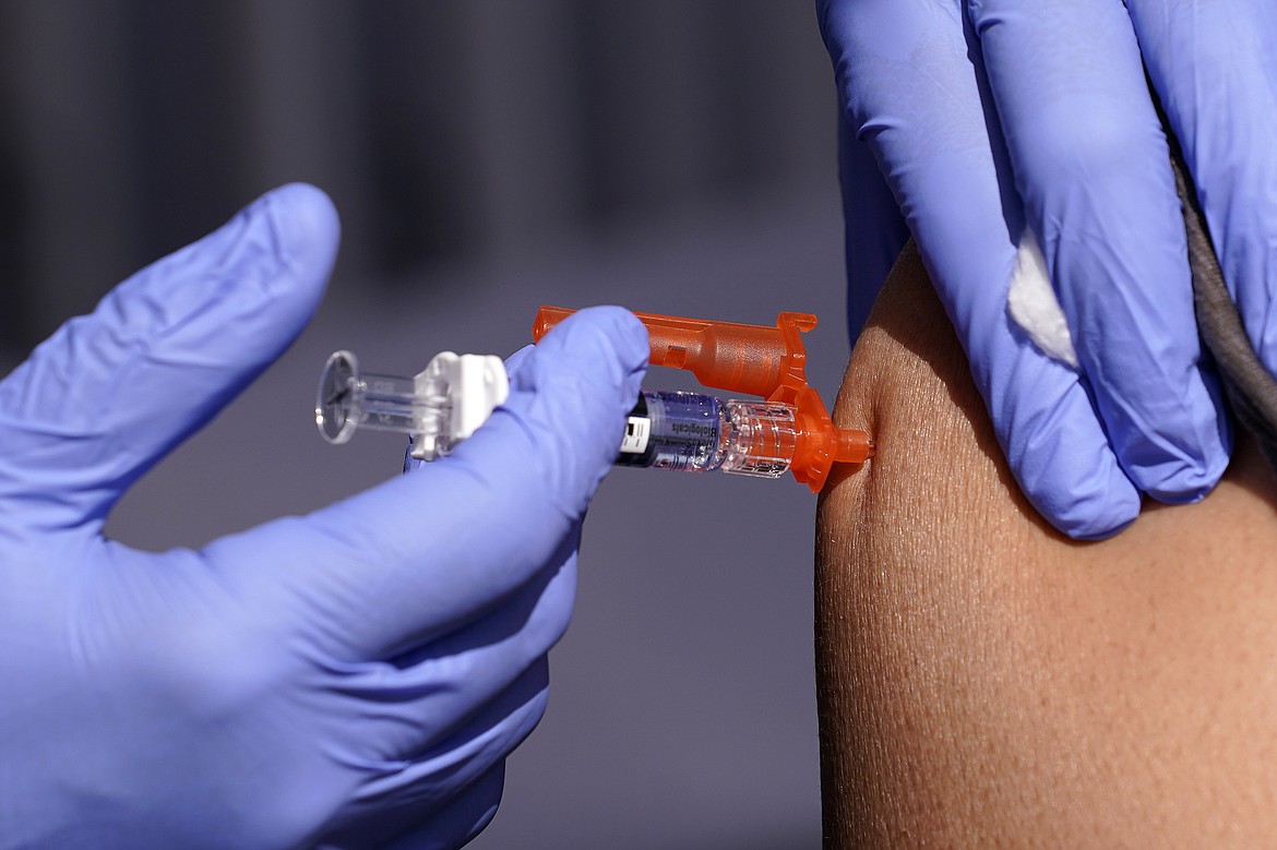 A patient is given a flu vaccine Oct. 28, 2022, in Lynwood, Calif. On Tuesday, July 2, 2024, the U.S. Department of Health and Human Services announced plans to pay Moderna $176 million to develop a mRNA vaccine to treat bird flu in people, as cases in dairy cows continue to mount across the country. (AP Photo/Mark J. Terrill, File)