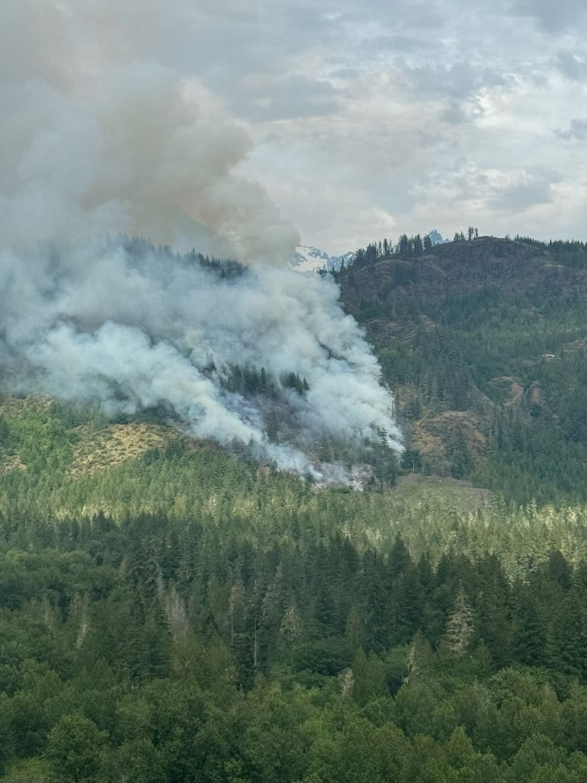 The terrain around the Dearinger Fire in the North Cascades has presented significant challenges for firefighters, but the blaze was 80% contained Monday.