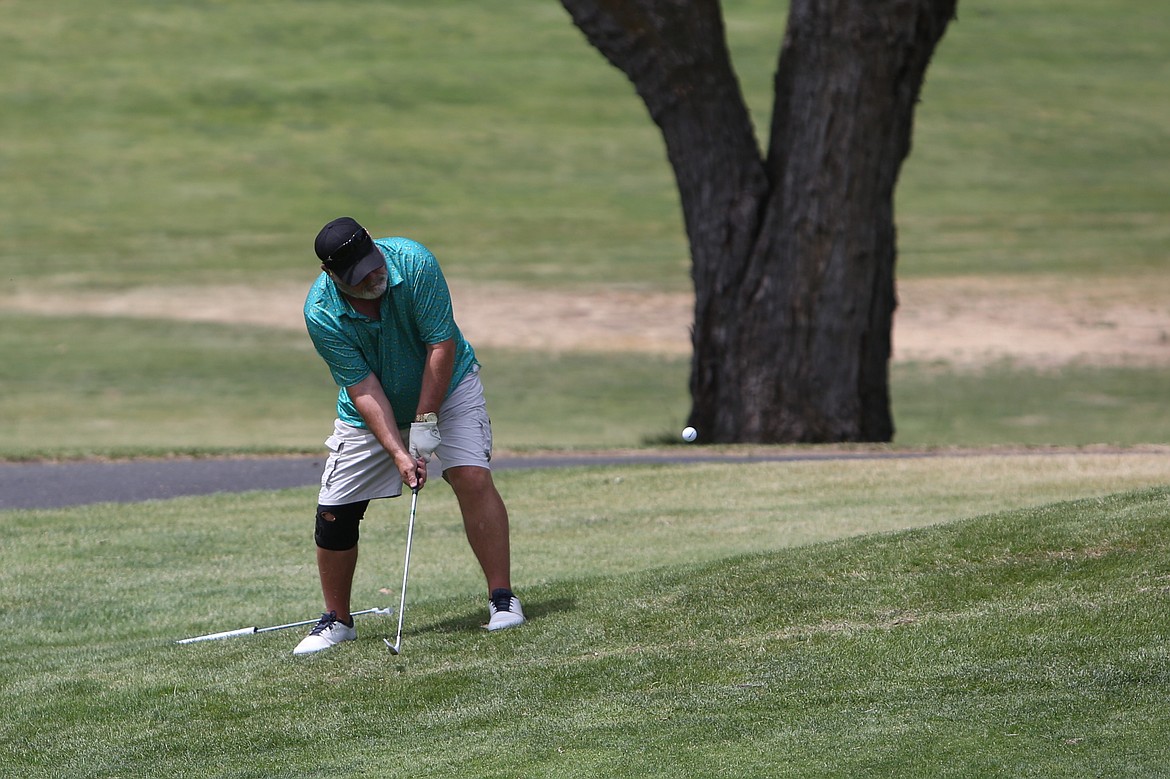 A golfer swings his club from just outside the green at the Sage Hills Golf Club in Warden at Waturday’s Please Hit Straight golf tournament benefitting the Warden High School wrestling program.