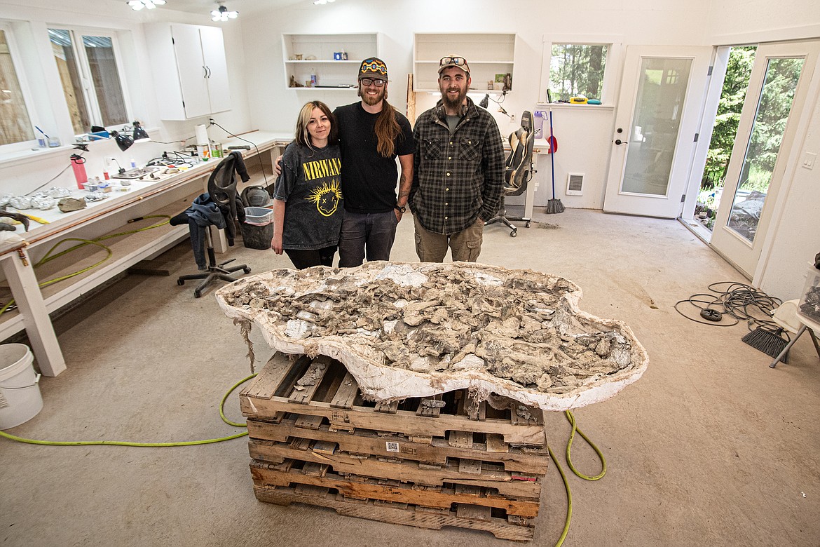 NorthWest Montana Fossils owners Chantel and Aamon Jaeger and preparator Zane Rhyneer pose with their archosaurs from Arizona, in the process of being cleaned for research and display at their Lake Blaine Road home on Thursday, June 6. (Avery Howe/Bigfork Eagle)