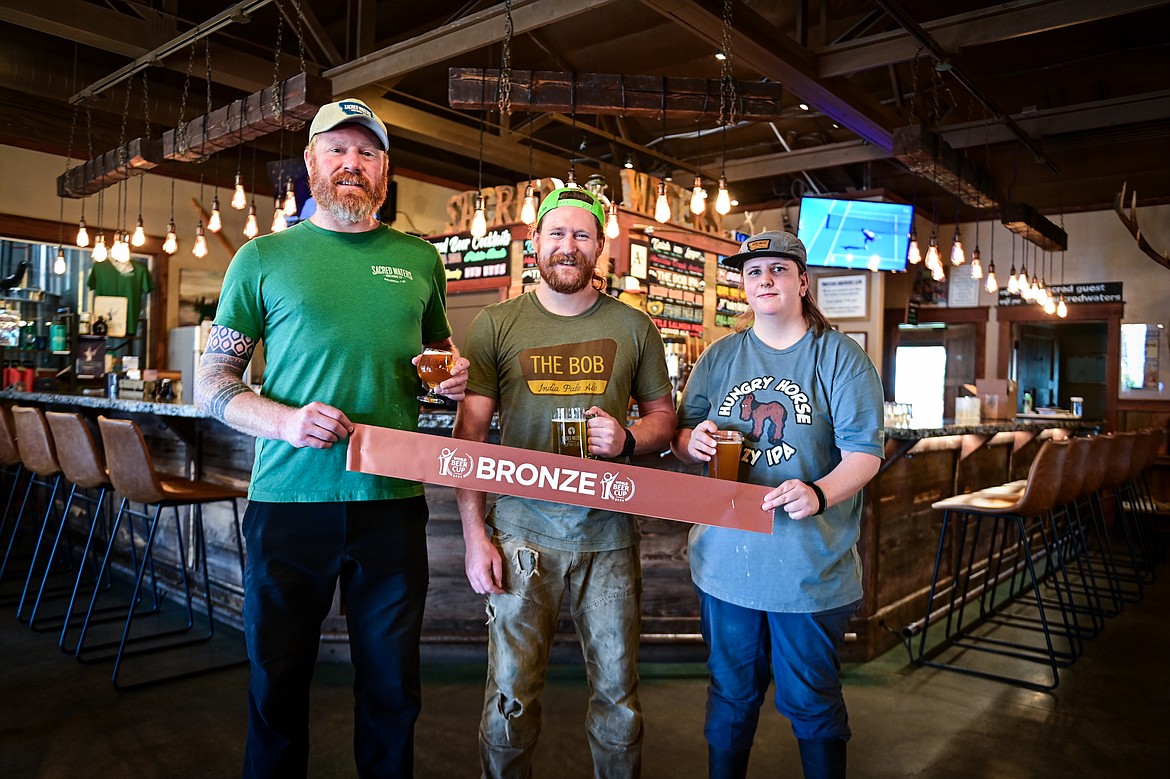 Head brewer Seth Orr, brewer Marty Vollmer and brewer Kylie Mortenson at Sacred Waters Brewing Company on Wednesday, July 3. Sacred Waters Brewing earned a bronze award for best chili beer at the World Beer Cup. (Casey Kreider/Daily Inter Lake)