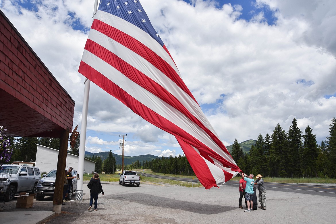 Patrons switch the flag at Happy's Inn, between Libby and Kalispell, which has one of the biggest American flags in the state. (Kate Heston/Daily Inter Lake)