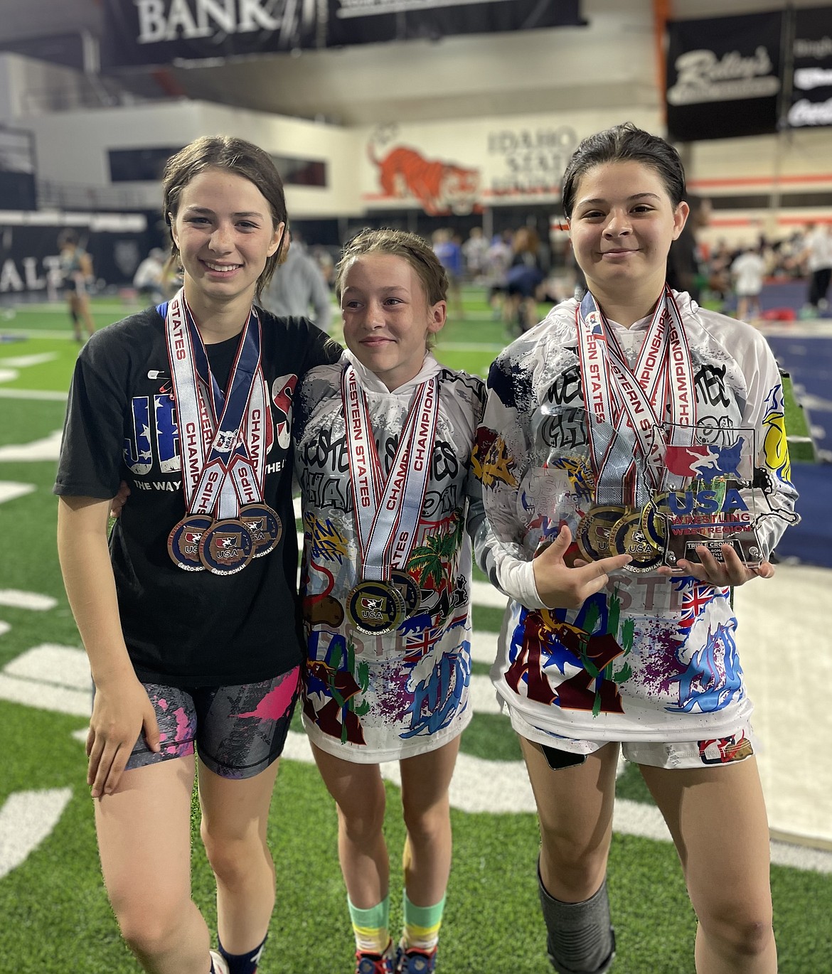 From left, Post Falls middle schoolers Kiera Dolan, Mackenzie Dolan and Kahli Brown show off the medals they earned at the Western States Championships.