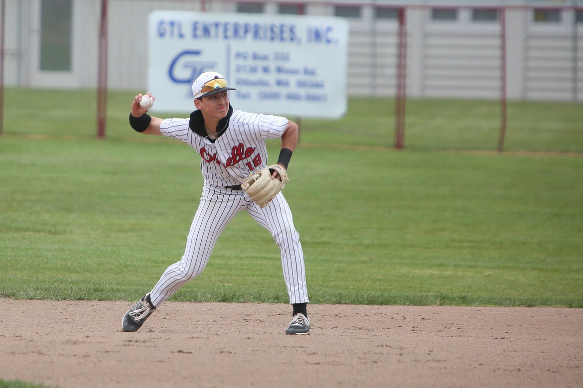 Red Raider Quade Gonzalez IV picks up a ground ball during the Othello High School baseball season. Gonzalez threw 15 strikeouts during the first game of Tuesday’s doubleheader.