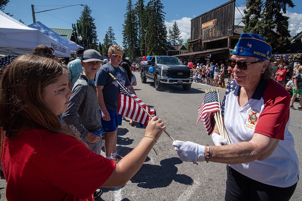 Members of the Bigfork VFW hand out American flags at the Fourth of July parade Thursday. (Avery Howe/Bigfork Eagle)