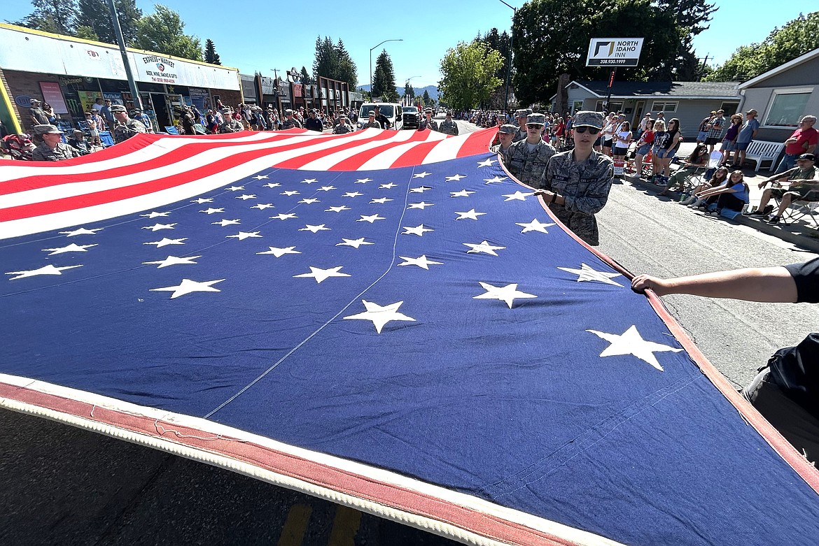 Young Marines carry a giant flag during the parade.