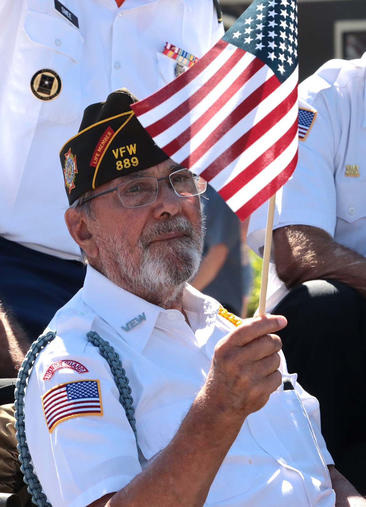 Veteran Charles Riffle waves a flag during Thursday's Fourth of July parade in Coeur d'Alene.