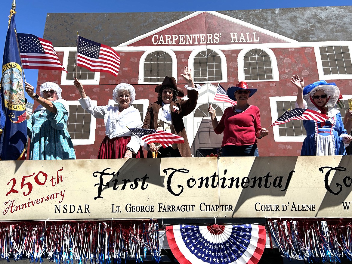 The Daughters of the American Revolution parade entry rolls on Sherman Avenue on Thursday.