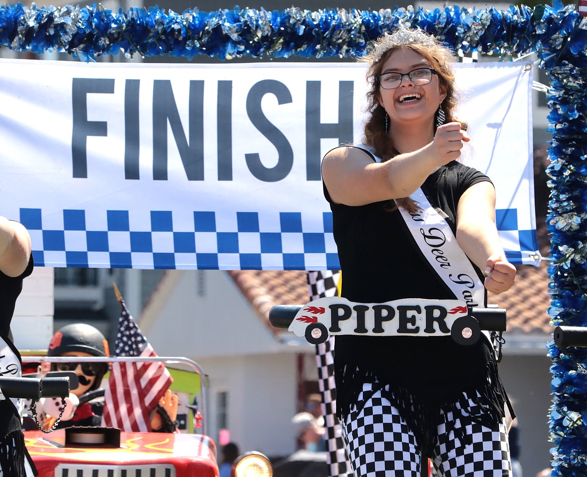 Piper Luginbill, Miss Deer Park, smiles as she shows off her moves in the Fourth of July parade.